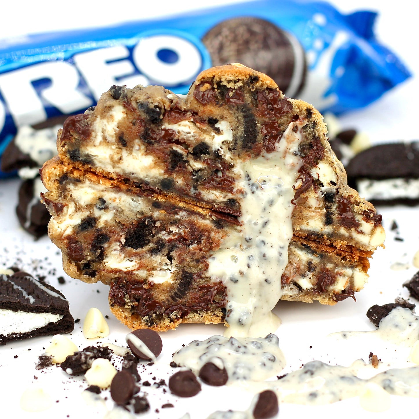Stuffed NYC-style cookie by Dolly’s Dough, cut in half to reveal layers of Oreo, chocolate chips, and cream filling. Order online for UK-wide cookie delivery