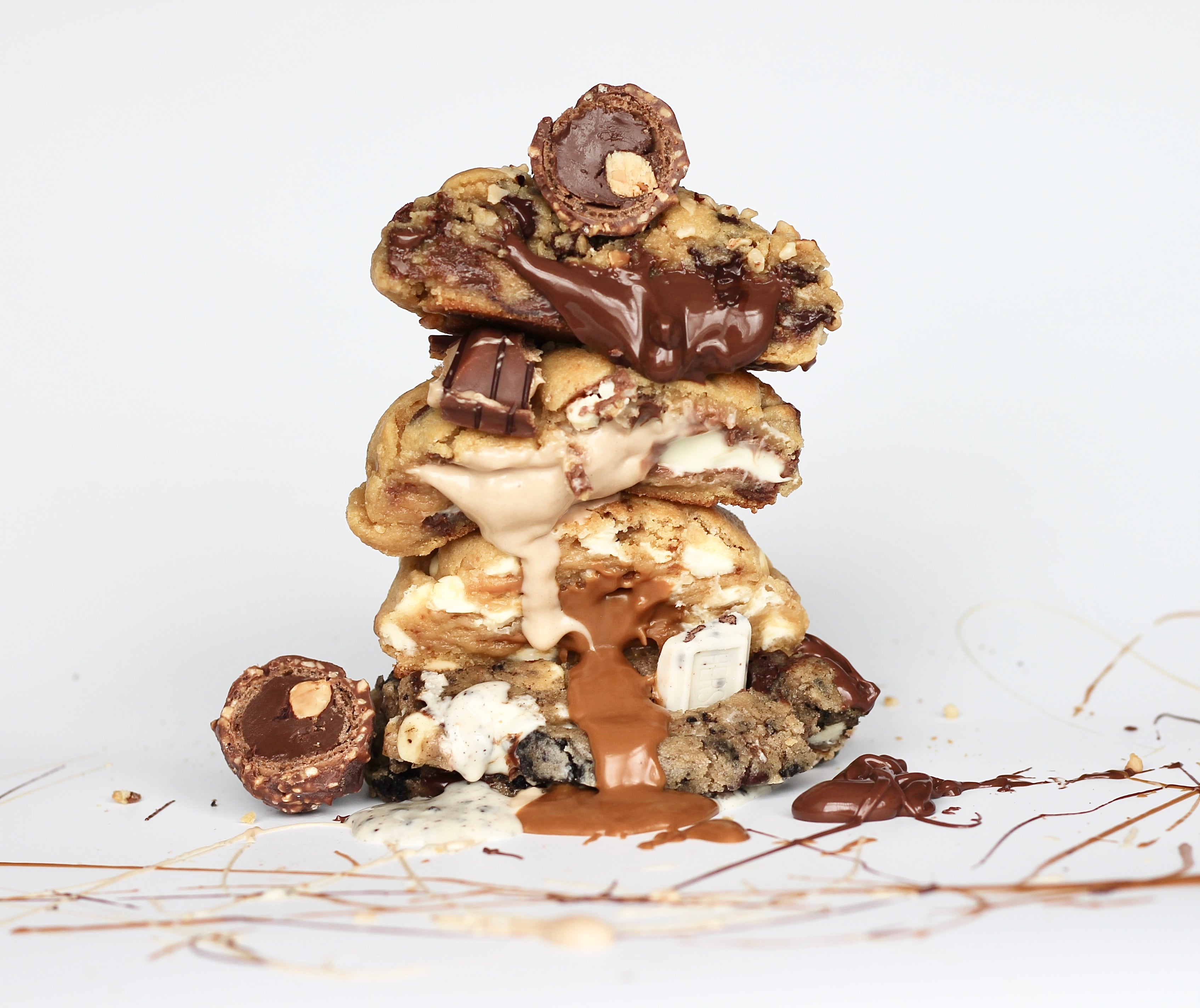 Stack of gooey, thick New York-style cookies from Dolly’s Dough, in Nutella, Biscoff, Kinder, and Oreo flavors. Handmade and loaded with chocolate chips, perfect for gifting or indulging. Taste the best NYC cookie flavors with nationwide UK delivery