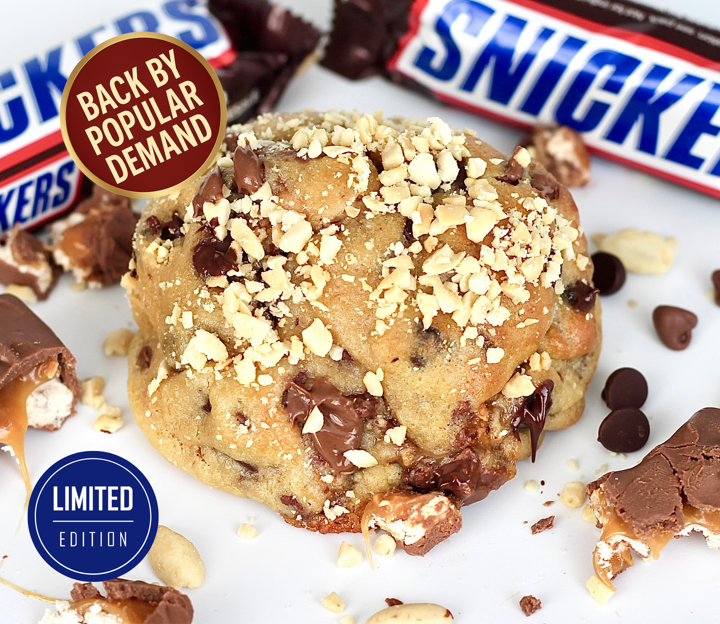 Snickers NYC cookie from Dolly’s Dough, topped with chopped peanuts and loaded with chocolate chips. Limited edition cookie, back by popular demand. Order online in the UK.