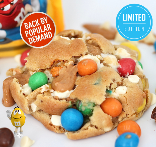 Close-up of Dolly’s Dough ‘The Nutter’ cookie, packed with Peanut M&M’s, white chocolate chips, and a peanut butter centre. Limited edition, back by popular demand